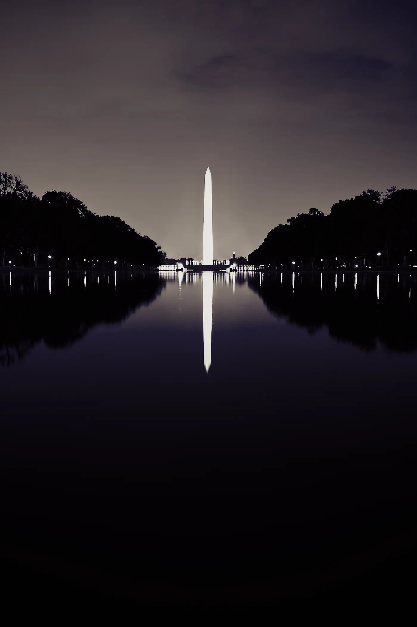 The Washington Monument at night, reflected in the Reflecting Pool
