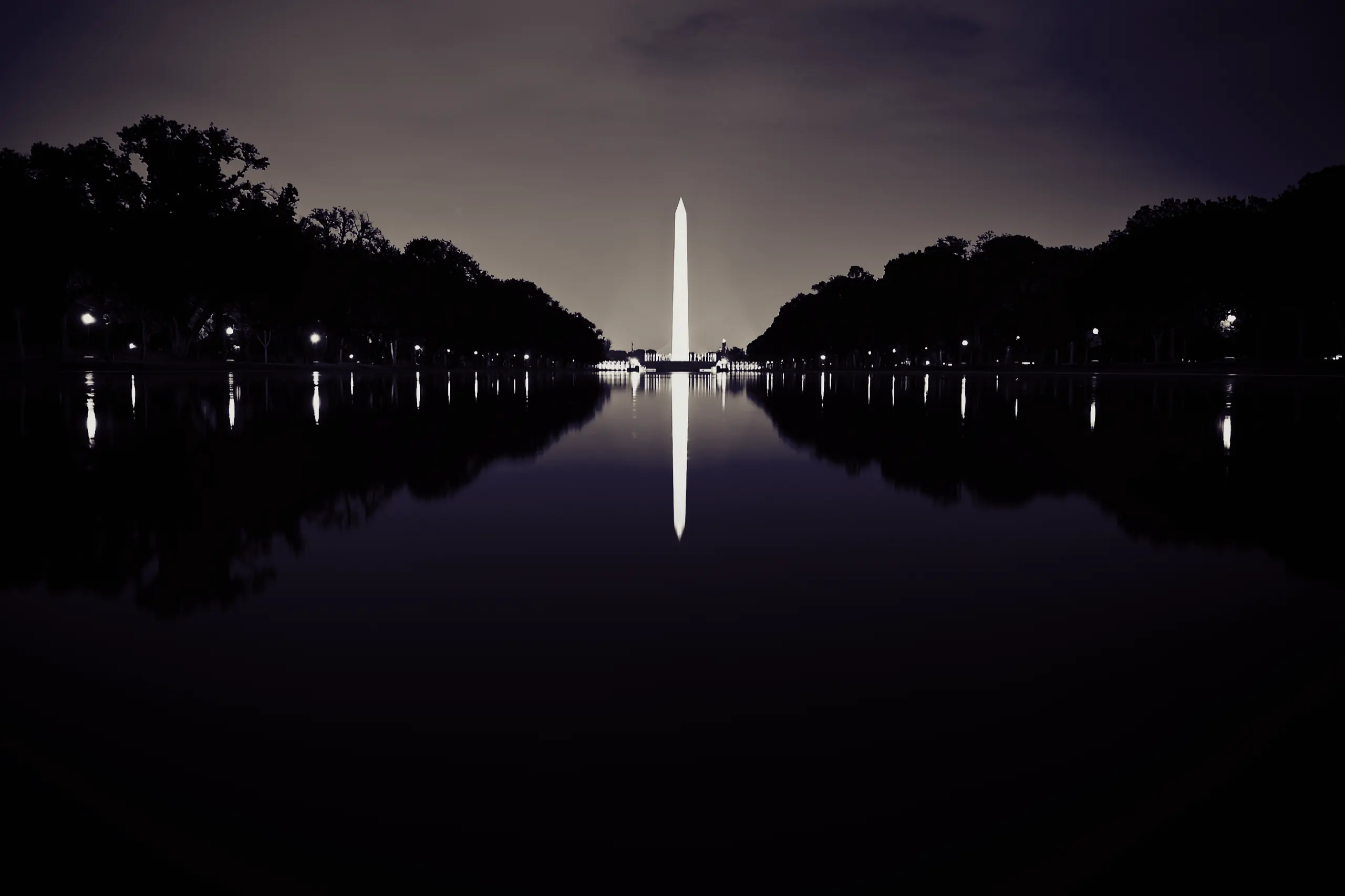 The Washington Monument at night, reflected in the Reflecting Pool